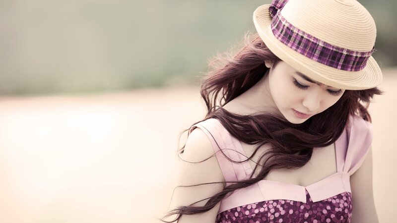 woman in hat looking down