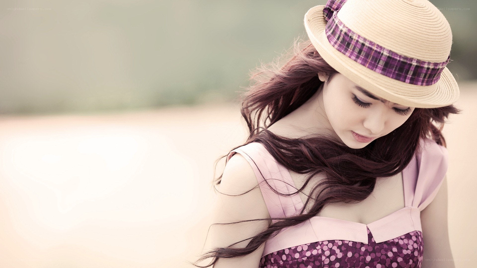 woman in hat looking down