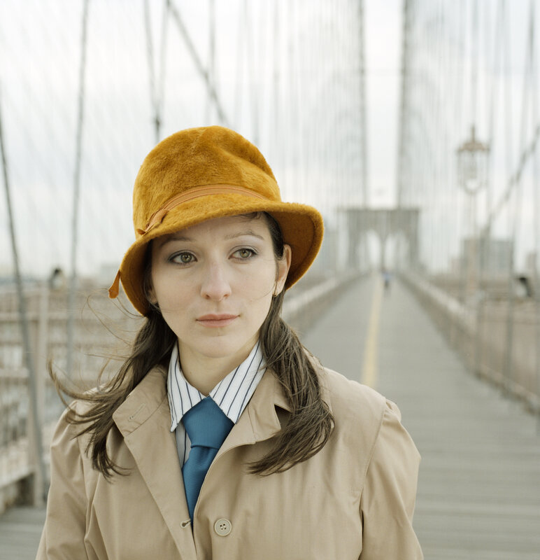 Woman in hat on a bridge