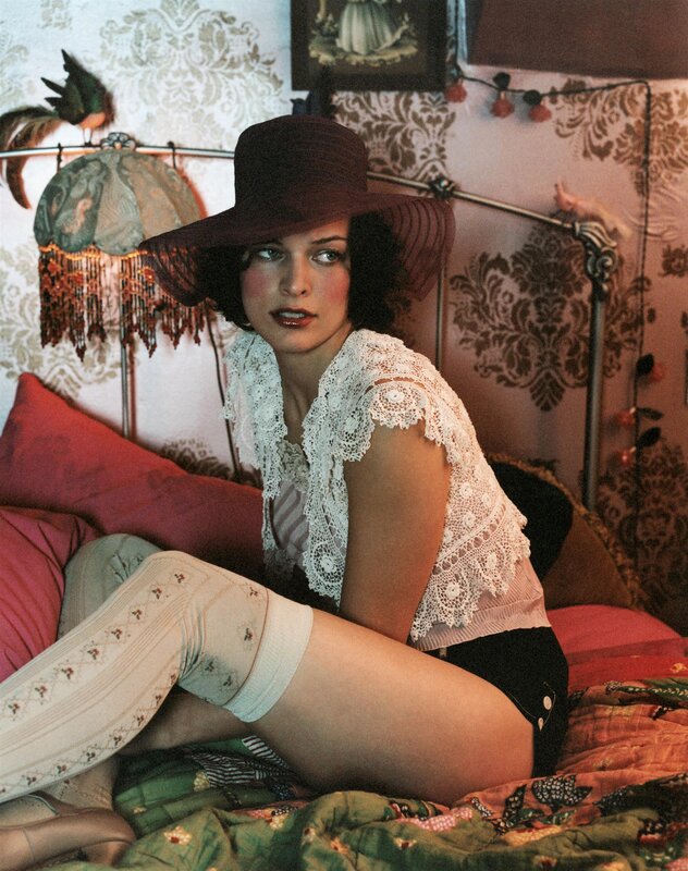 woman in hat on bed