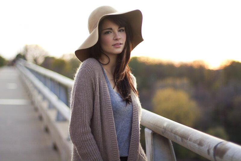 woman in hat on bridge