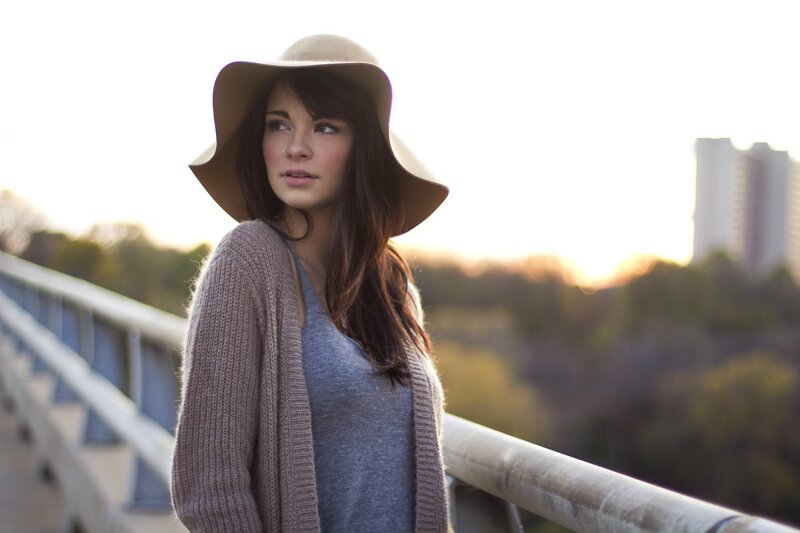 woman in hat on bridge