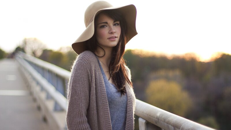 woman in hat on bridge