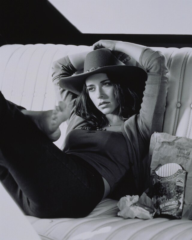 woman in hat on couch