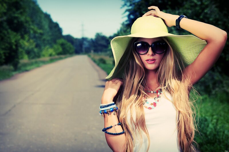 woman in hat on country road