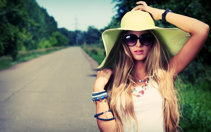 woman in hat on country road