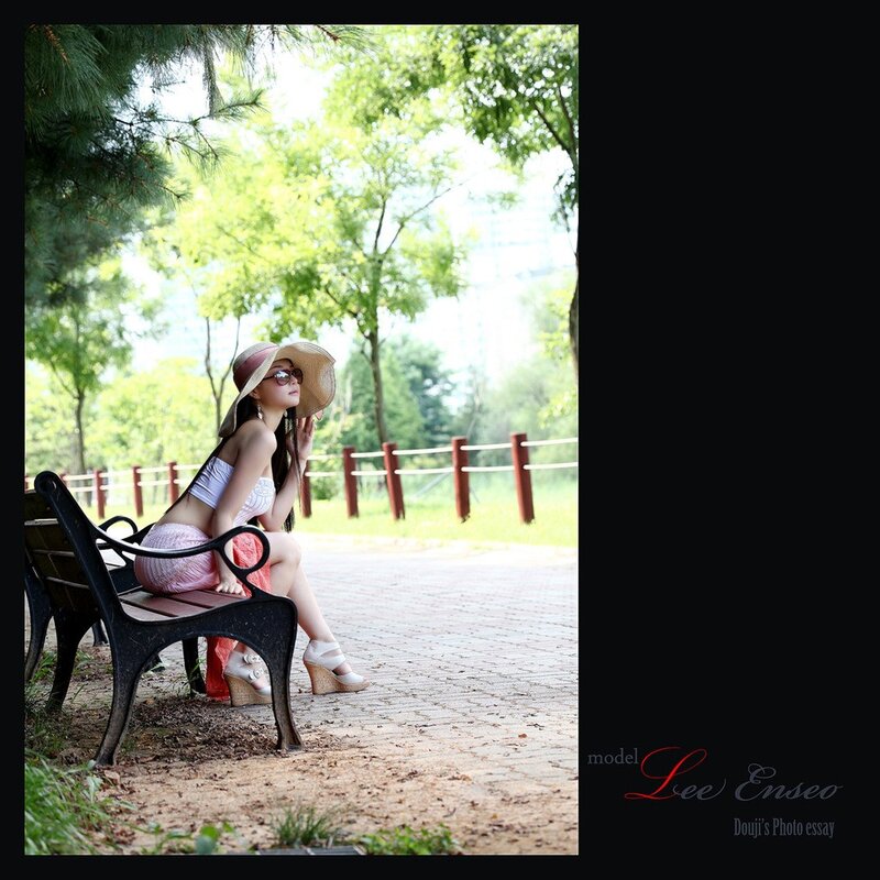 Woman in hat on park bench