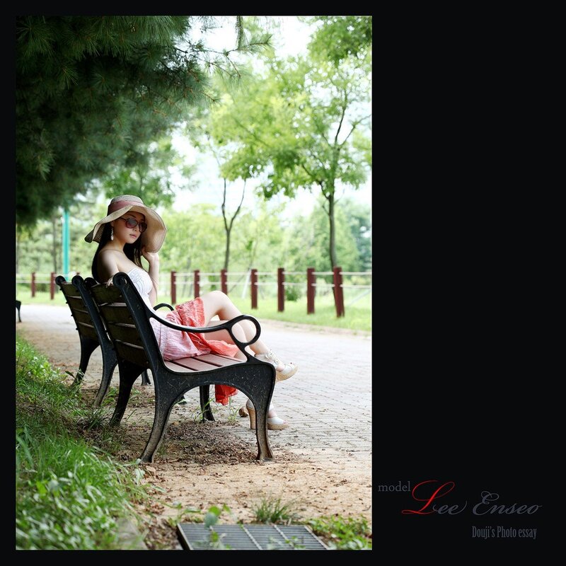 Woman in hat on park bench
