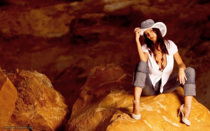 woman in hat on rocks