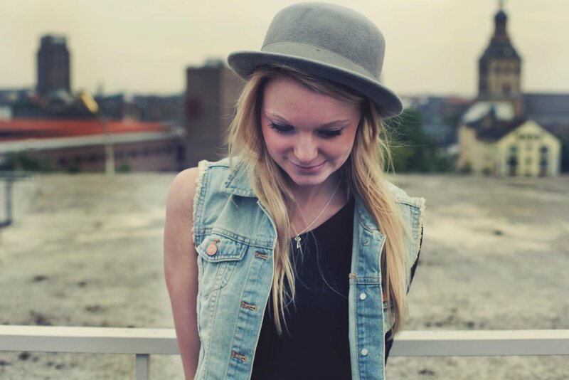 Woman in hat on rooftop