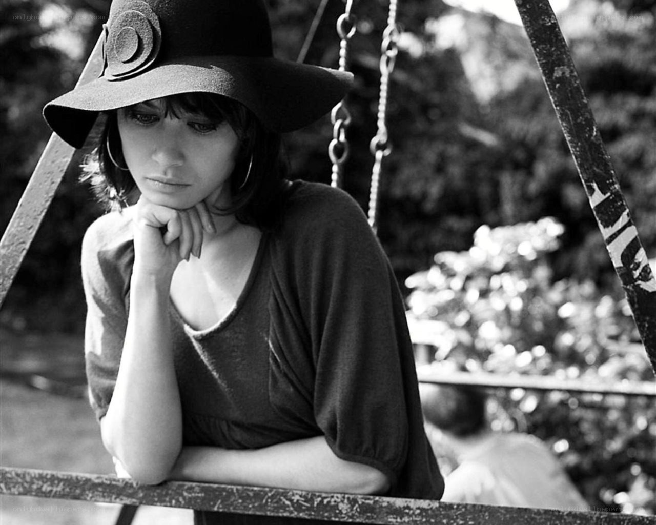woman in hat on swing