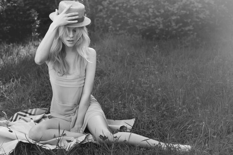 Woman in Hat Sitting on Blanket
