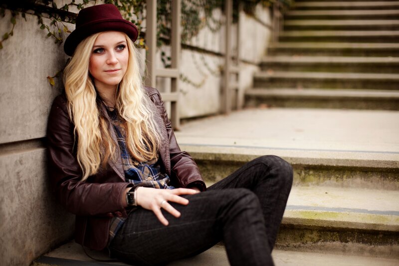 woman in hat sitting on steps