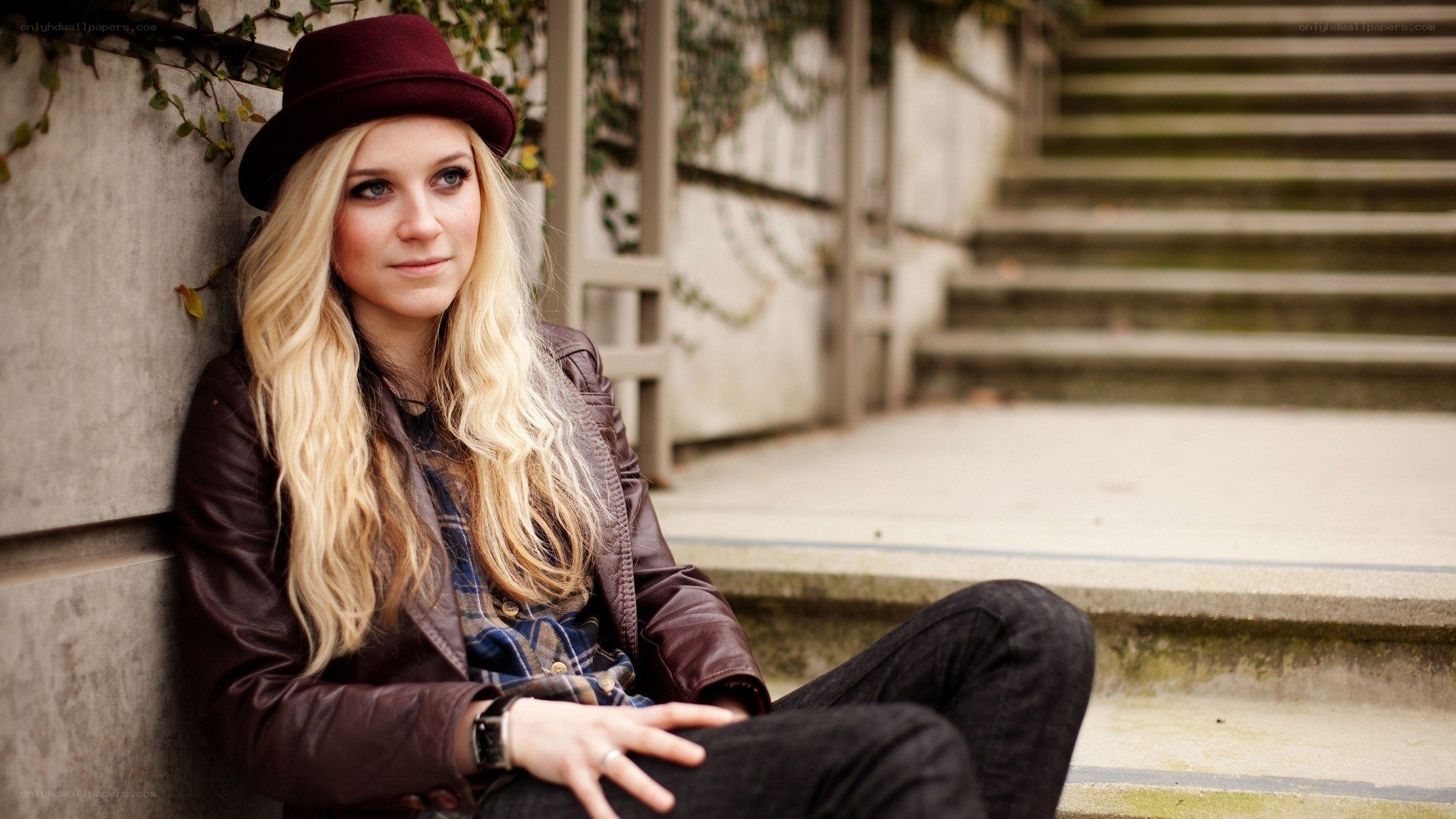 woman in hat sitting on steps