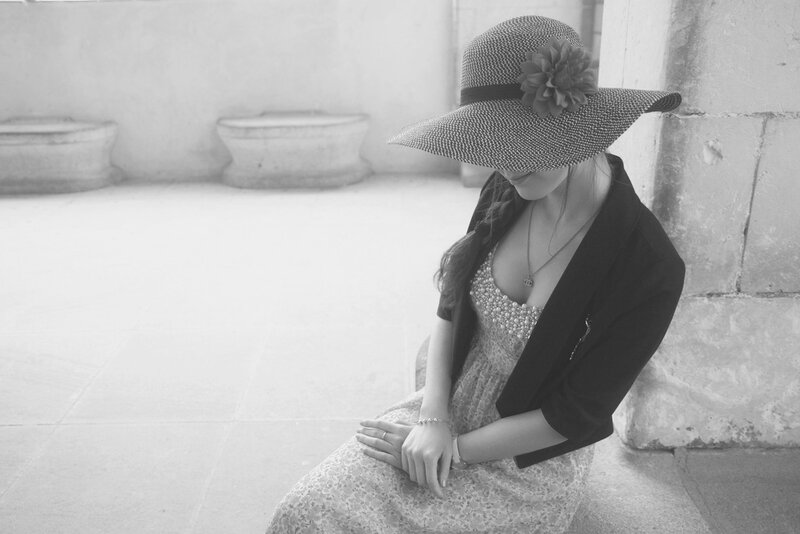 Woman in Hat Sitting