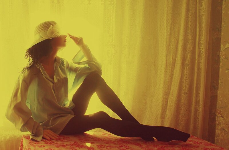 Woman in Hat Sitting — Yellow