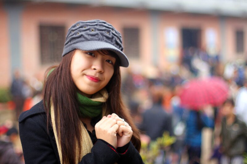 woman in hat smiling at camera