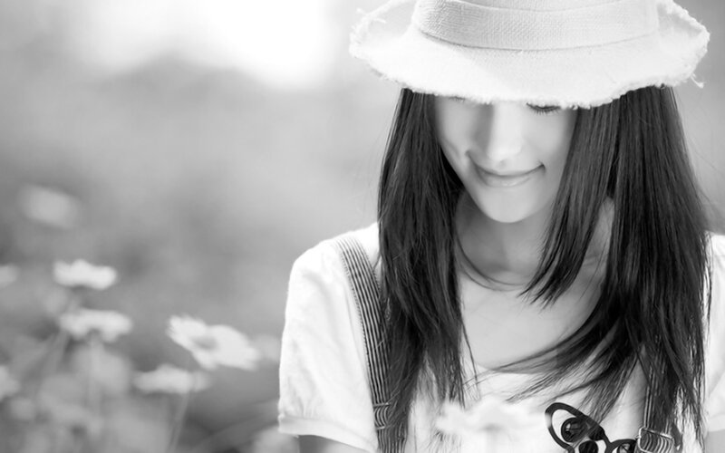 woman in hat smiling outdoors