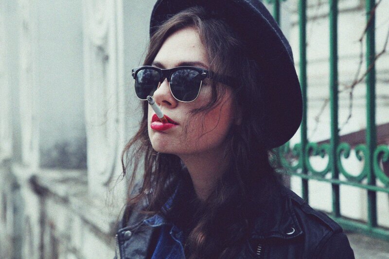 woman in hat smoking cigarette