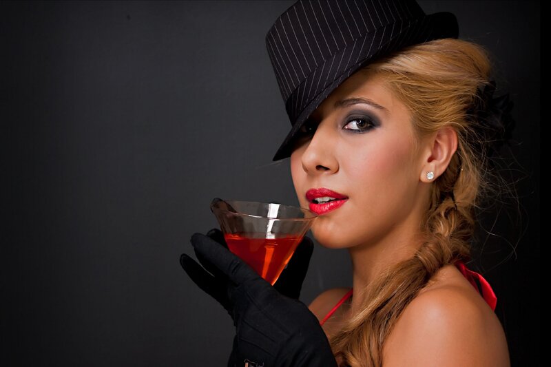 woman in hat with cocktail
