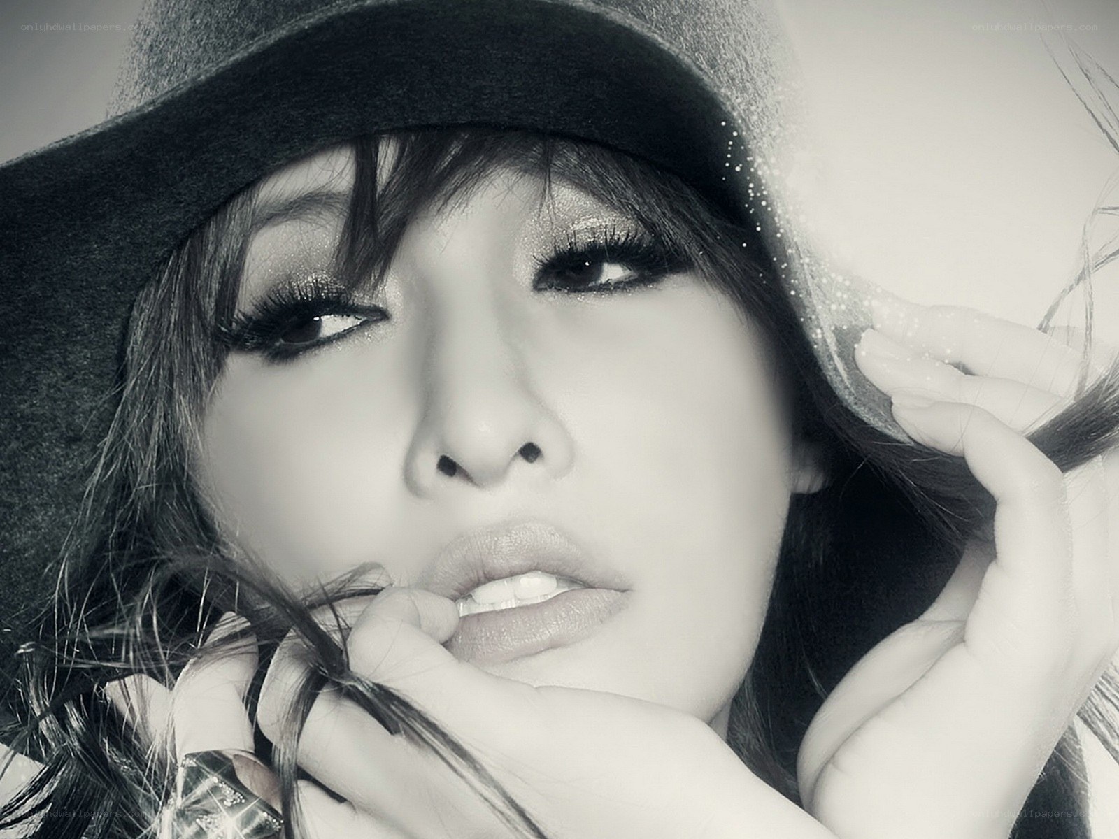 woman in hat with dramatic makeup