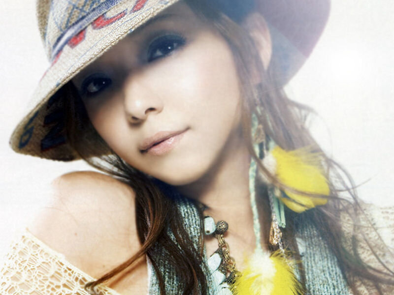 woman in hat with feather earrings