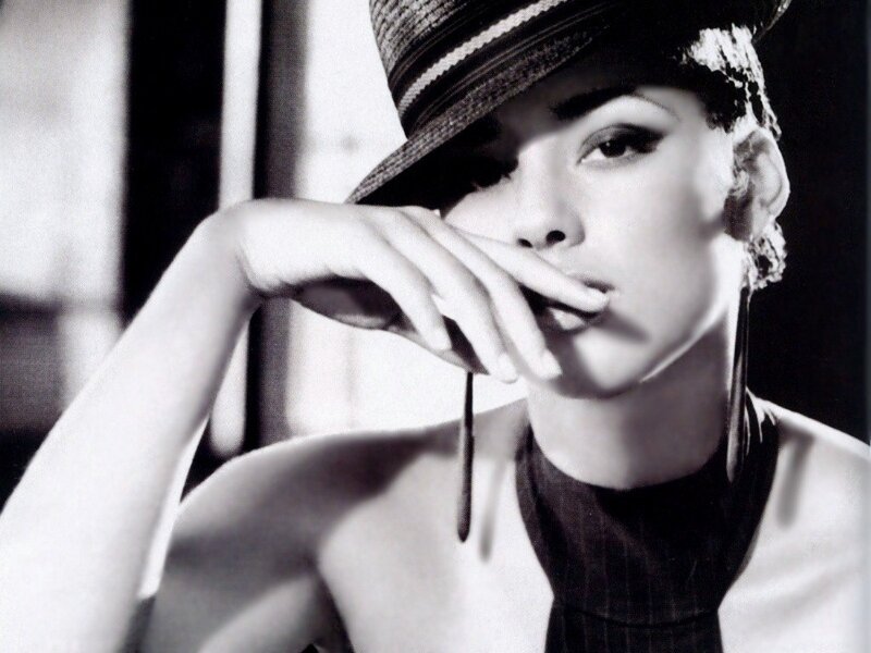 woman in hat with hand on chin