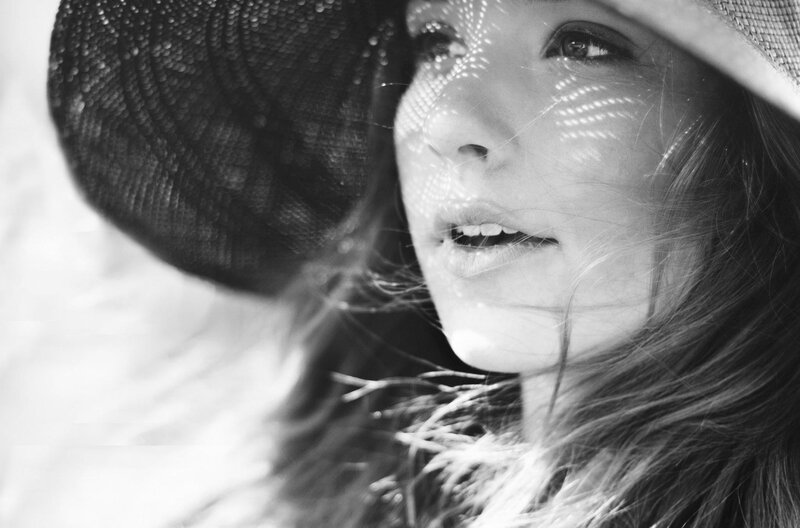 woman in hat with light patterns