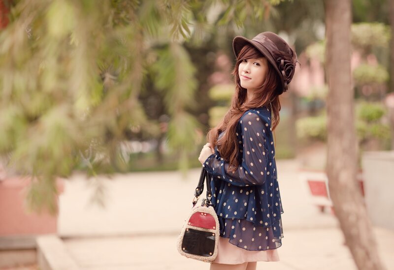 woman in hat with polka-dot dress