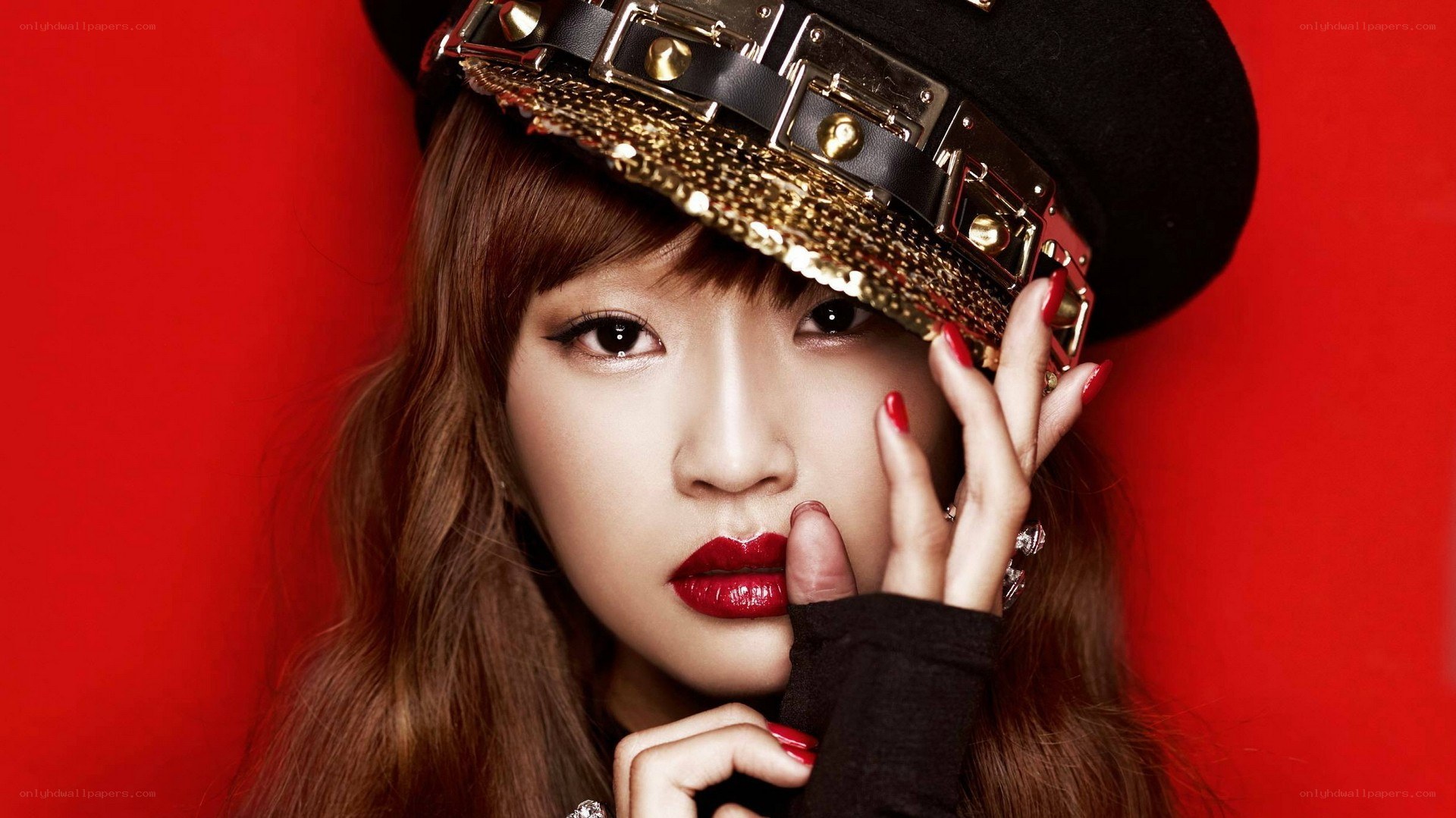 woman in hat with red background