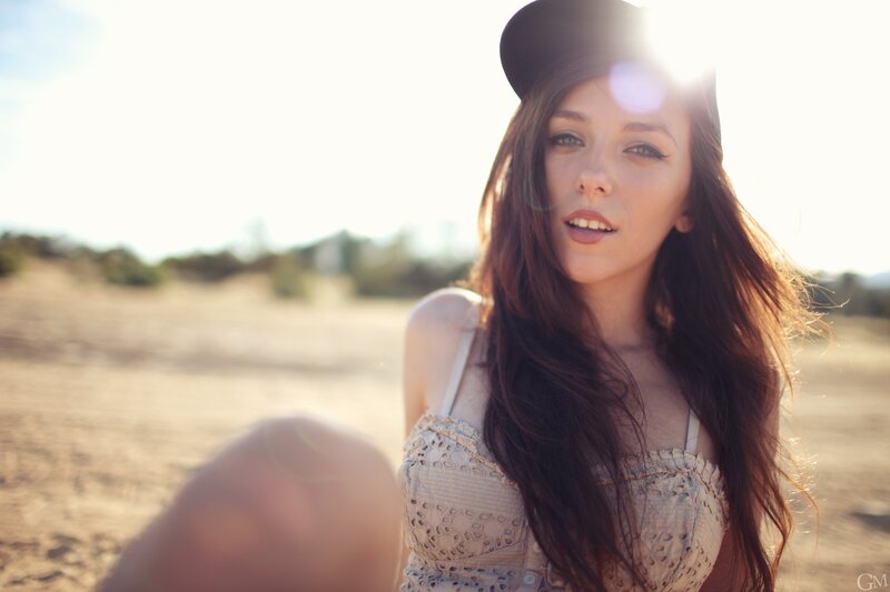 woman in hat with sun flare