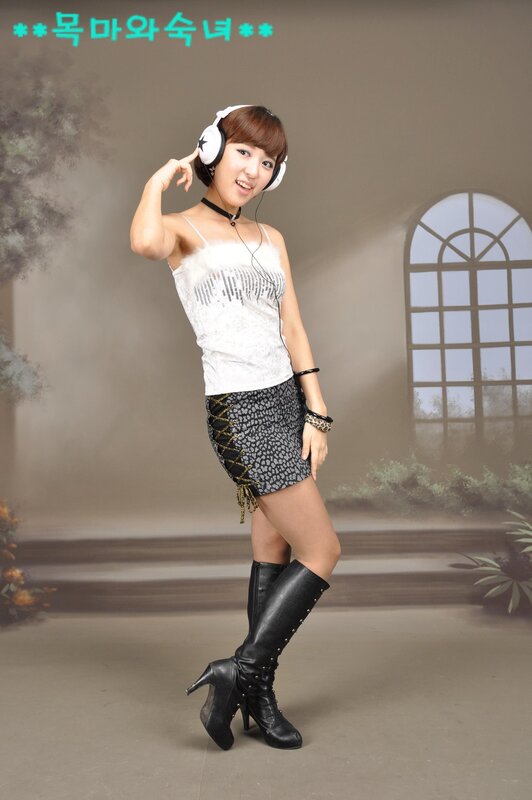 woman in headphones and boots