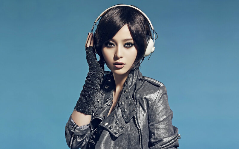 woman in headphones and leather jacket