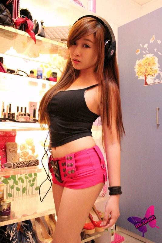 woman in headphones and pink shorts
