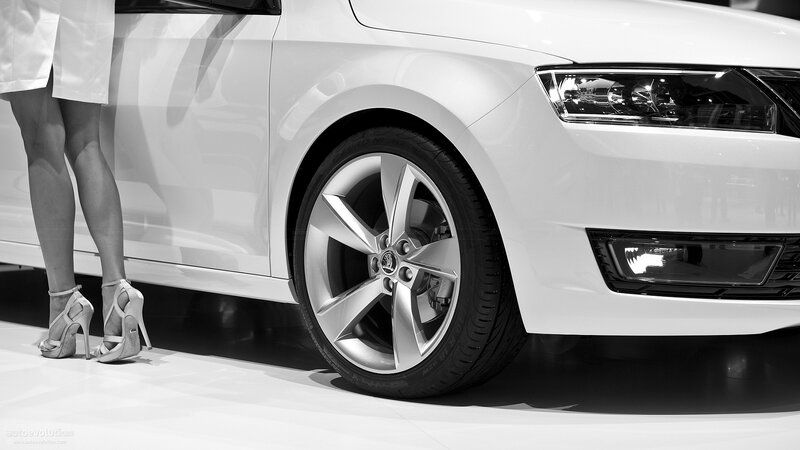 woman in heels beside white car