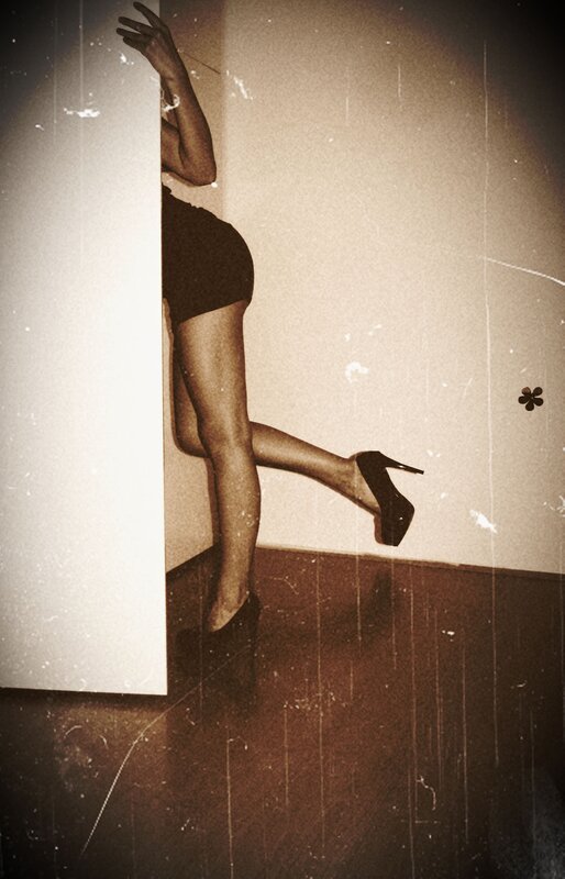 woman in high heels peeking from corner