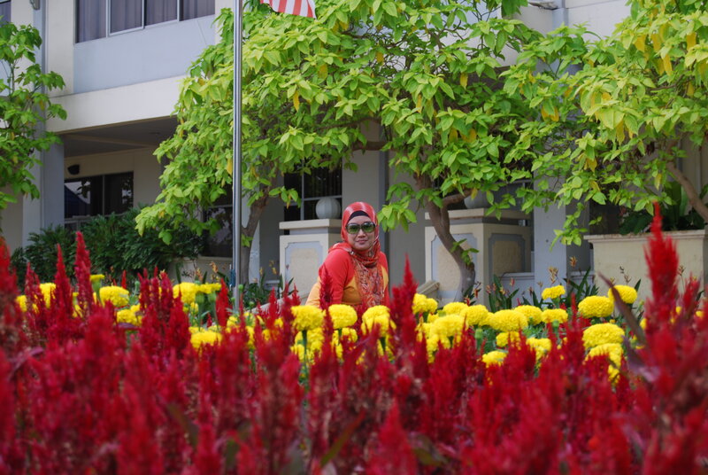 Woman in Hijab Among Flowers