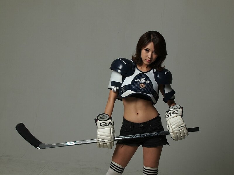 woman in hockey gear holding stick