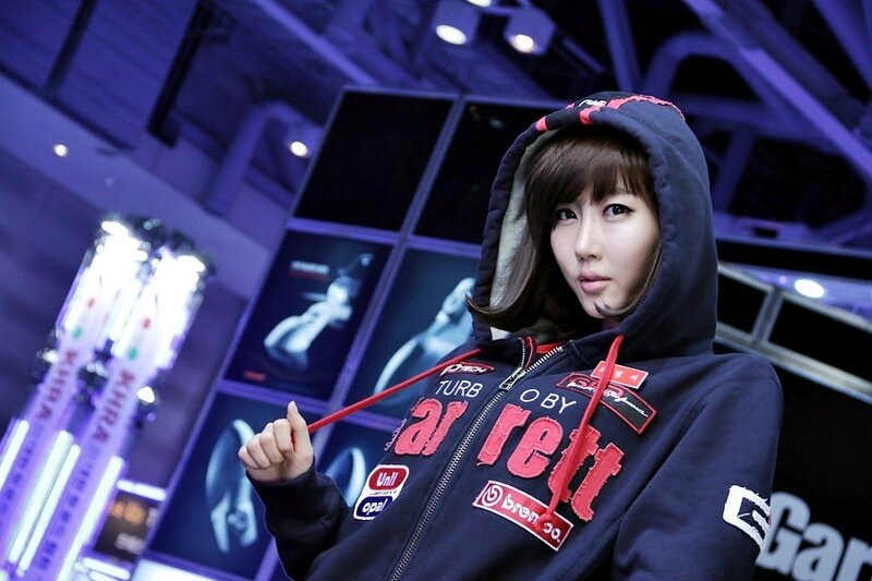 woman in hooded jacket at event