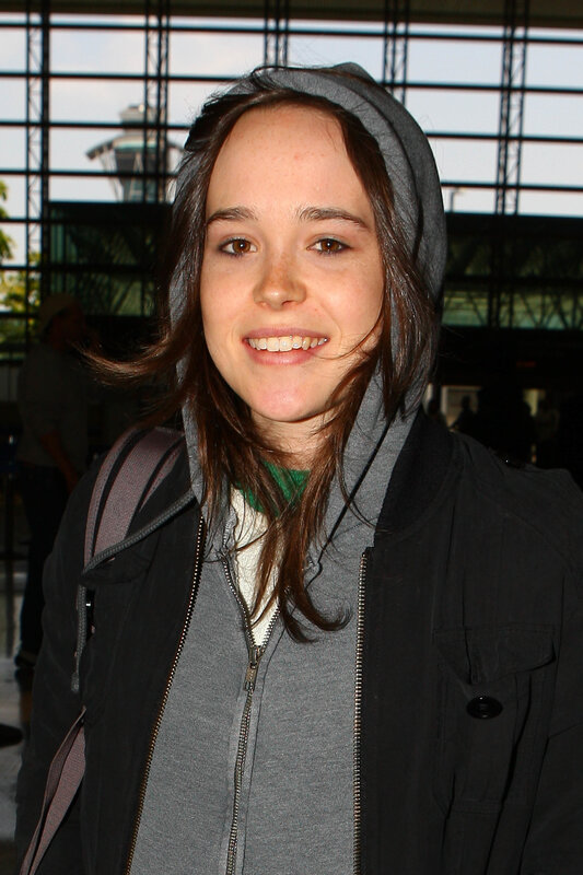 woman in hooded jacket smiling