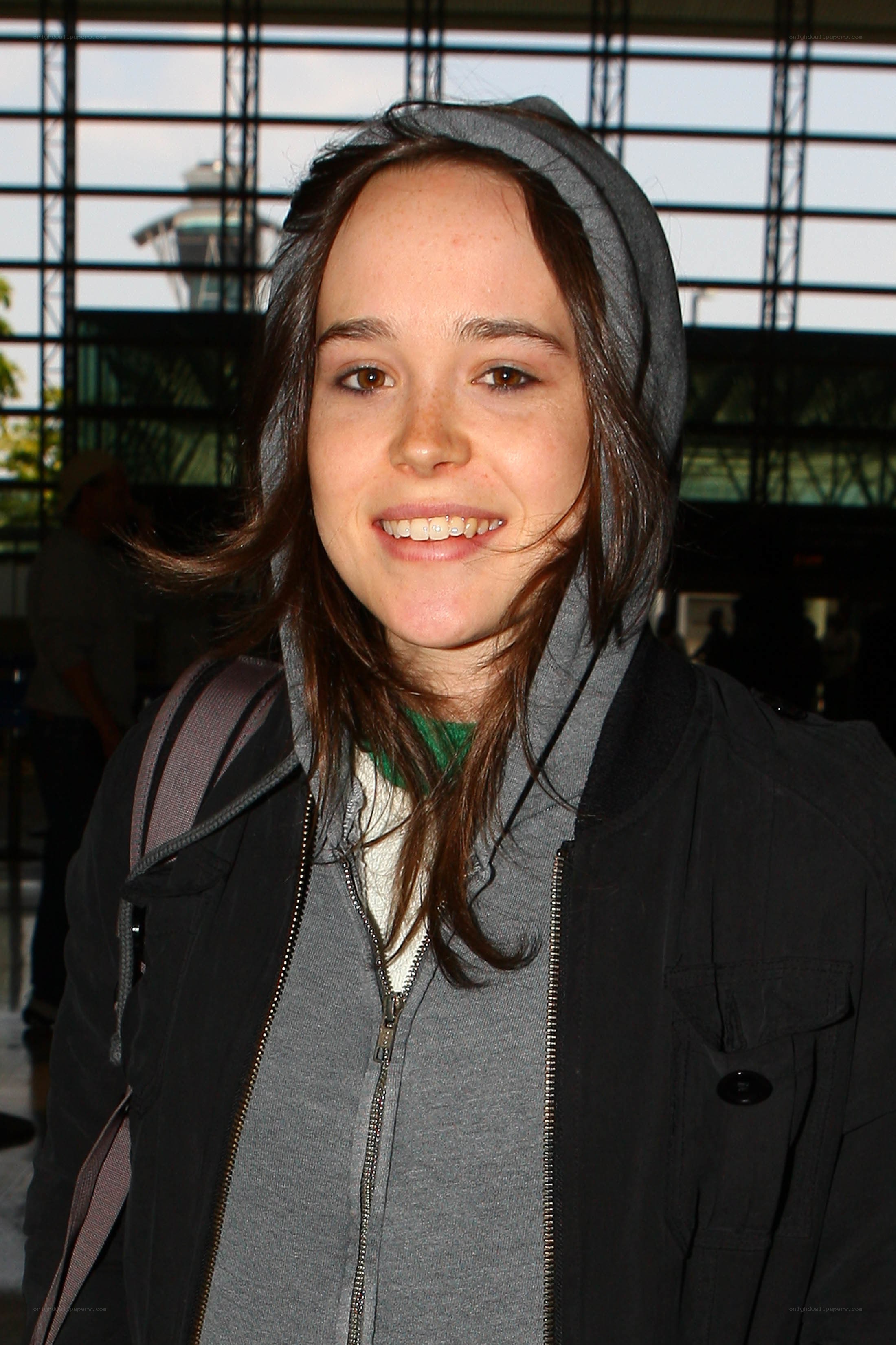 woman in hooded jacket smiling