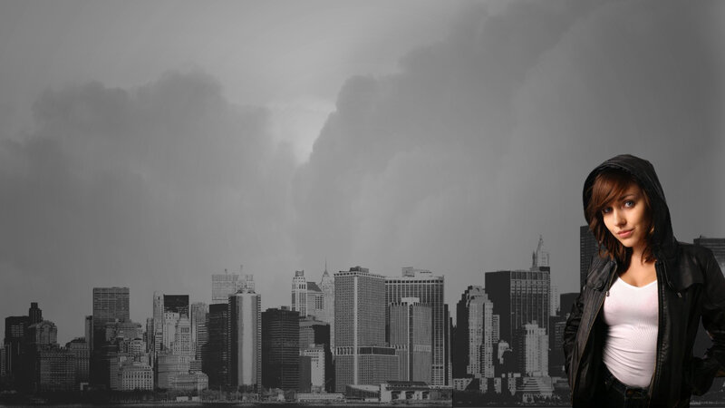 woman in hoodie against city skyline