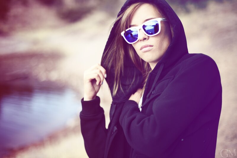 woman in hoodie and sunglasses
