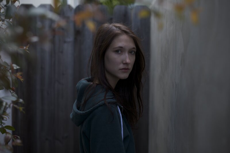 woman in hoodie looking back