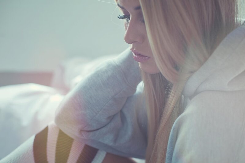 woman in hoodie looking down