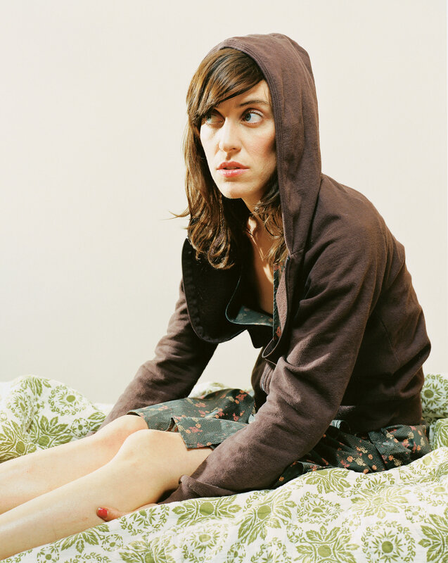 woman in hoodie on bed