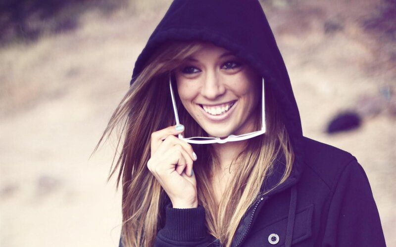 woman in hoodie smiling