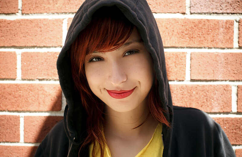 woman in hoodie smiling