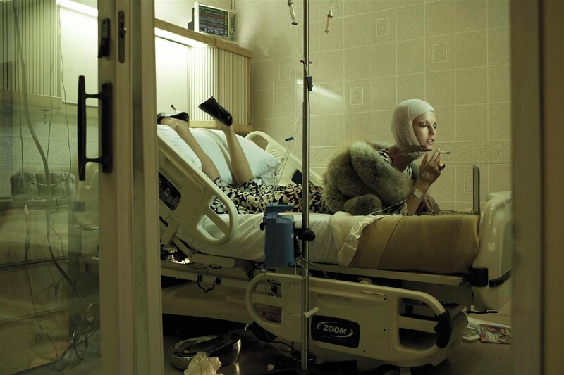 Woman in hospital bed smoking