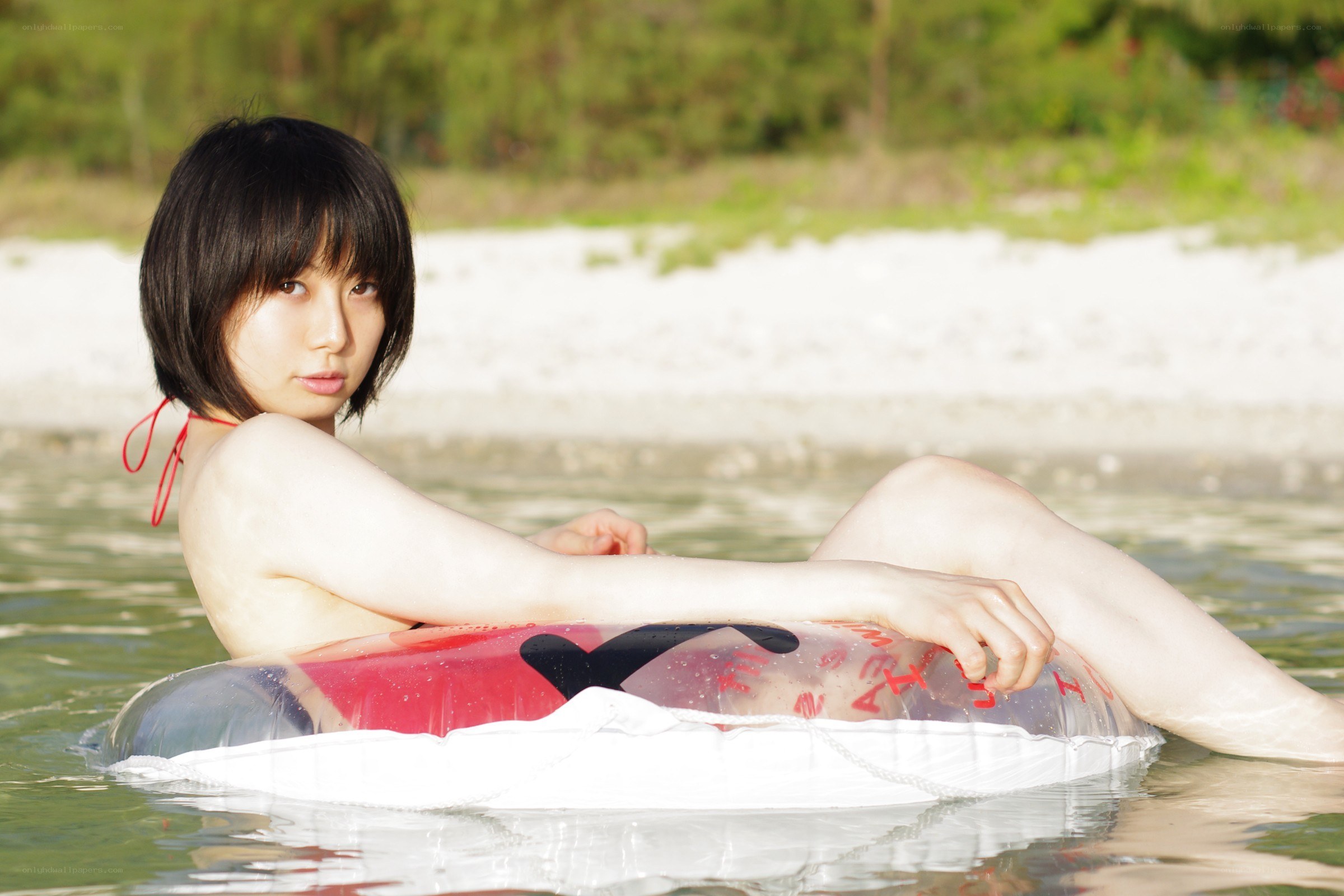 woman in inflatable ring at beach